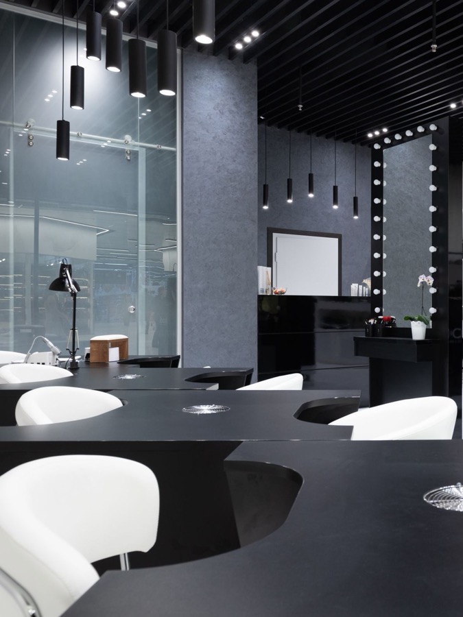 A sleek, modern beauty salon interior with styling chairs