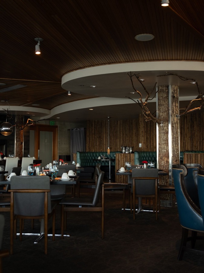 An elegant restaurant dining room set with warm lighting